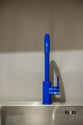 a blue pipe sitting on top of a sink at Ernesto Apartment in Athens