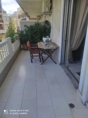 a patio with a table and chairs on a balcony at Piece of Gold 7 minutes from Acropolis in Athens