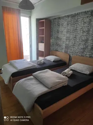 a bedroom with two beds and a window at Piece of Gold 7 minutes from Acropolis in Athens