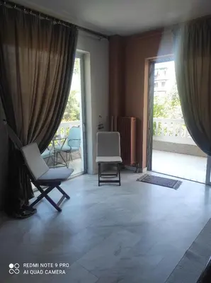 a living room with chairs and a large window at Piece of Gold 7 minutes from Acropolis in Athens
