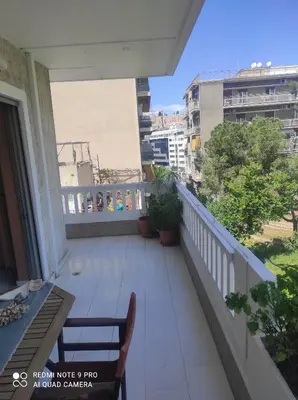 a balcony with a table and chairs on a building at Piece of Gold 7 minutes from Acropolis in Athens