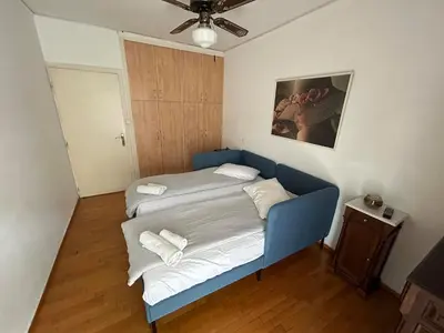 a small room with a blue bed in it at Piece of Gold 7 minutes from Acropolis in Athens
