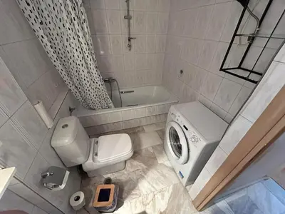 a bathroom with a toilet and a washing machine at Piece of Gold 7 minutes from Acropolis in Athens