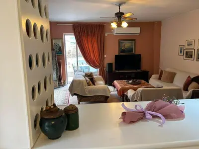 a living room with a table and a living room at Piece of Gold 7 minutes from Acropolis in Athens