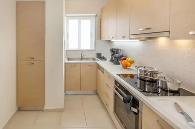 a kitchen with a sink and a stove top oven at Urban Oasis with Acropolis Views by GHH in Athens