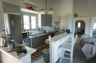 a kitchen with a sink and a counter top at Lili and Blue - Charming house in Porto Rafti