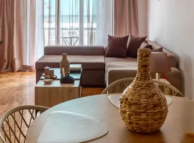 a living room with a table and a couch at KalaGans CosyHome in Athens