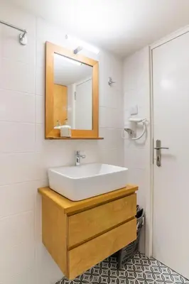 a bathroom with a sink and a mirror at Bee Home - Apartment in Kypseli Central Athens in Athens