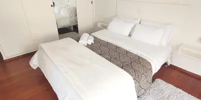 a bedroom with a bed with white sheets and pillows at Bee Home - Apartment in Kypseli Central Athens in Athens