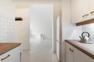 a kitchen with white walls and a refrigerator at Bee Home - Apartment in Kypseli Central Athens in Athens