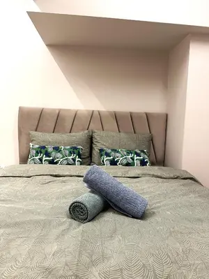 a bed with a pillow on top of it at City Center Acropolis area Maisonette Modern House in Athens