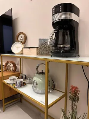 a coffee maker sitting on top of a shelf at City Center Acropolis area Maisonette Modern House in Athens