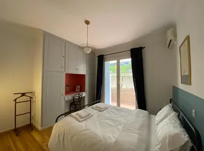 a bedroom with a bed and a large window at 2 Bedroom Apartment near Prestigious Kolonaki Square in Athens