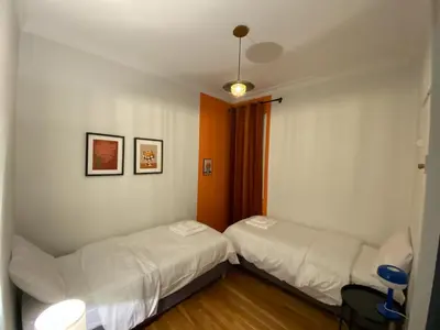 a bedroom with two beds and a window at 2 Bedroom Apartment near Prestigious Kolonaki Square in Athens