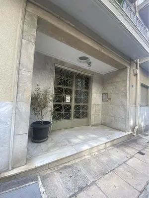 a building with a door with a potted plant at 2 Bedroom Apartment near Prestigious Kolonaki Square in Athens