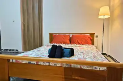 a bedroom with a bed with red pillows at Live like a Local in Athens in Piraeus