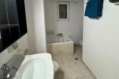 a bathroom with a white tub and a sink at Live like a Local in Athens in Piraeus