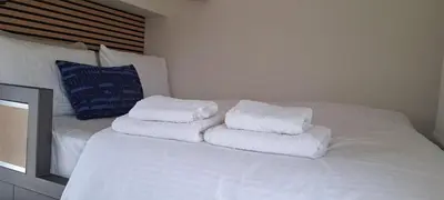 a white bed with four white towels on it at Panormou Cityview Loft in Athens