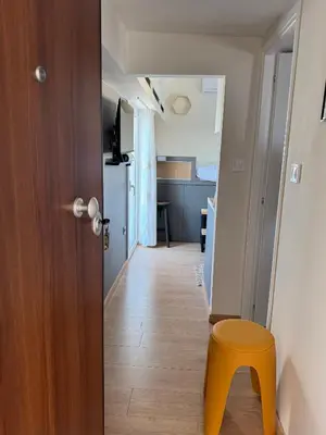 a hallway with a yellow stool and a room at Panormou Cityview Loft in Athens
