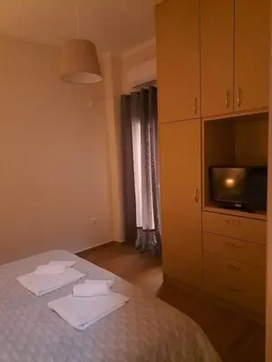 a bedroom with a bed with towels on it at Urban Nest Apartments in Athens