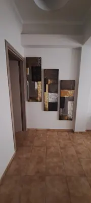 a room with three pieces of art on the wall at Urban Nest Apartments in Athens