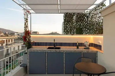 a balcony with a bar with a view at Aristotelus Studio Jacuzzi & Acropolis View in Athens