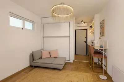 a living room with a couch and a table at Aristotelus Studio Jacuzzi & Acropolis View in Athens