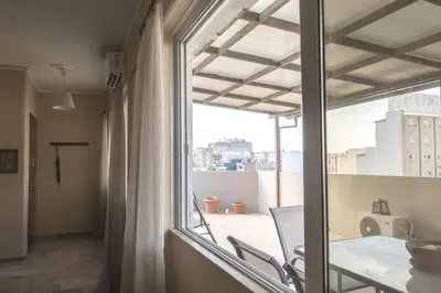a view of a balcony from a room with a window at In the Heart of the Port Area in Piraeus