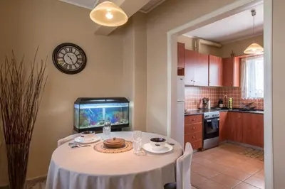 a kitchen with a table with a fish tank on the wall at In the Heart of the Port Area in Piraeus