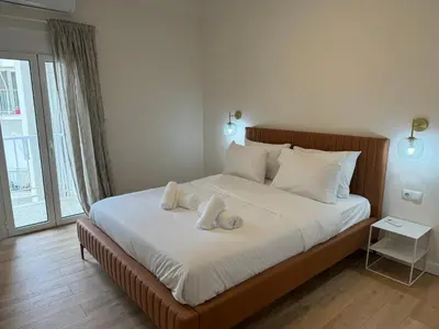 a bedroom with a large bed with towels on it at Harbour Getaway in Piraeus