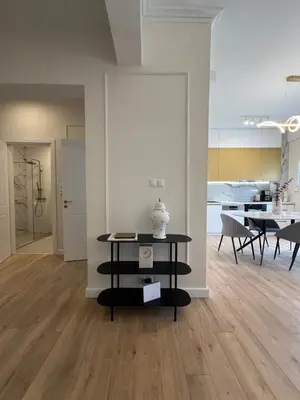 a living room with a table and a dining room at Harbour Getaway in Piraeus