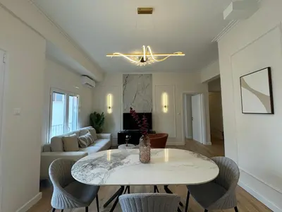 a living room with a table and chairs at Harbour Getaway in Piraeus