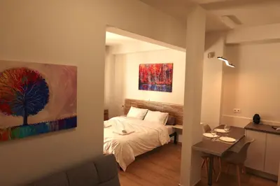 a bedroom with a bed and a painting on the wall at Urban Charming Studio for 3 by MPS in Athens