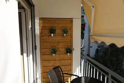 a wooden door with potted plants on it on a balcony at Urban Charming Studio for 3 by MPS in Athens