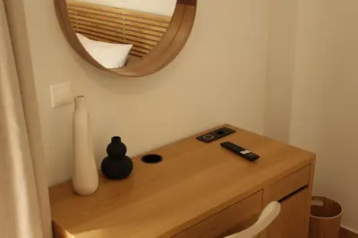 a dressing table with a mirror and a remote control at Urban Charming Studio for 3 by MPS in Athens