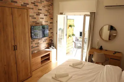 a bedroom with a bed and a mirror at Urban Charming Studio for 3 by MPS in Athens