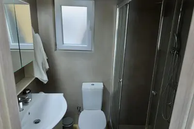 a bathroom with a toilet and a sink and a shower at Urban Charming Studio for 3 by MPS in Athens