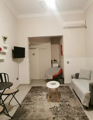 a living room with a couch and a table at Emily's house in Athens