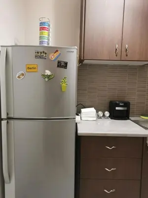 a kitchen with a refrigerator with magnets on it at Emily's house in Athens