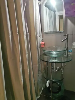 a bathroom with a glass sink and a mirror at Emily's house in Athens