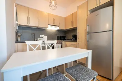 a kitchen with a white counter and a refrigerator at Athens Center 2 BDR Family Apartment at Zografou ! in Athens