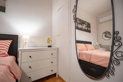 a mirror in a bedroom with a bed and a dresser at Athens Center 2 BDR Family Apartment at Zografou ! in Athens