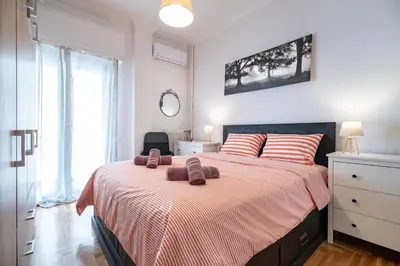 a bedroom with a bed with two towels on it at Athens Center 2 BDR Family Apartment at Zografou ! in Athens