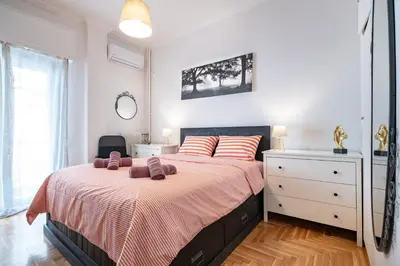 a bedroom with a bed with two towels on it at Athens Center 2 BDR Family Apartment at Zografou ! in Athens