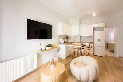 a living room with a table and a kitchen at City Wanderer Modern Loft in Athens