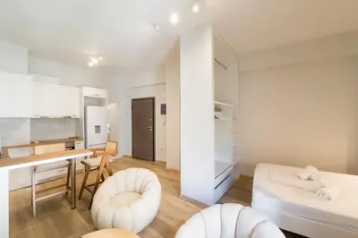 a white apartment with a kitchen and a bedroom at City Wanderer Modern Loft in Athens