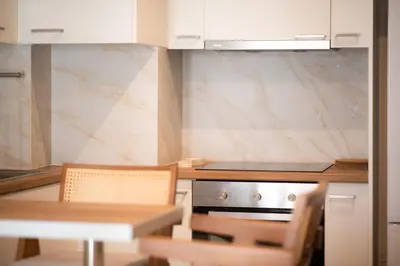 a kitchen with a table and chairs and a stove at City Wanderer Modern Loft in Athens