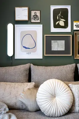 a living room with a couch with pictures on the wall at Bonjour Athens in Athens
