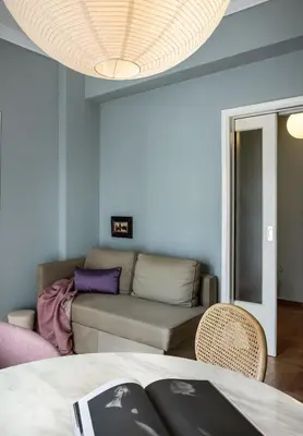 a living room with a couch and a table at Bonjour Athens in Athens