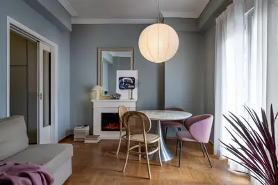 a living room with a table and chairs at Bonjour Athens in Athens